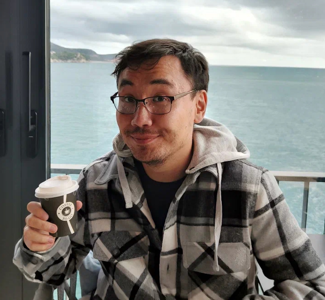 Ivan with coffee by the sea